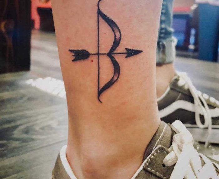 Bow and arrow knee tattoo