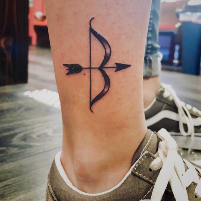 Bow and arrow knee tattoo